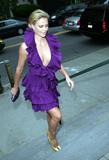 Charlize Theron in very low-cut purple dress shows cleavage at Christian Dior Cruise 2009 Collection